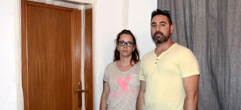 Foto portada: Meritxell Moreno i el seu marit, a la porta que tenen tapiada al seu pis. Autor: David B.