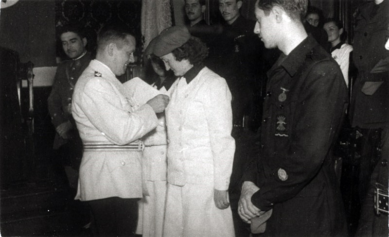 Elhers imponiendo la Insignia de Honor de las Juventudes Hitlerianas Magda Coret, a su izquierda Pedro Riba. Autor desconocido/AHS
